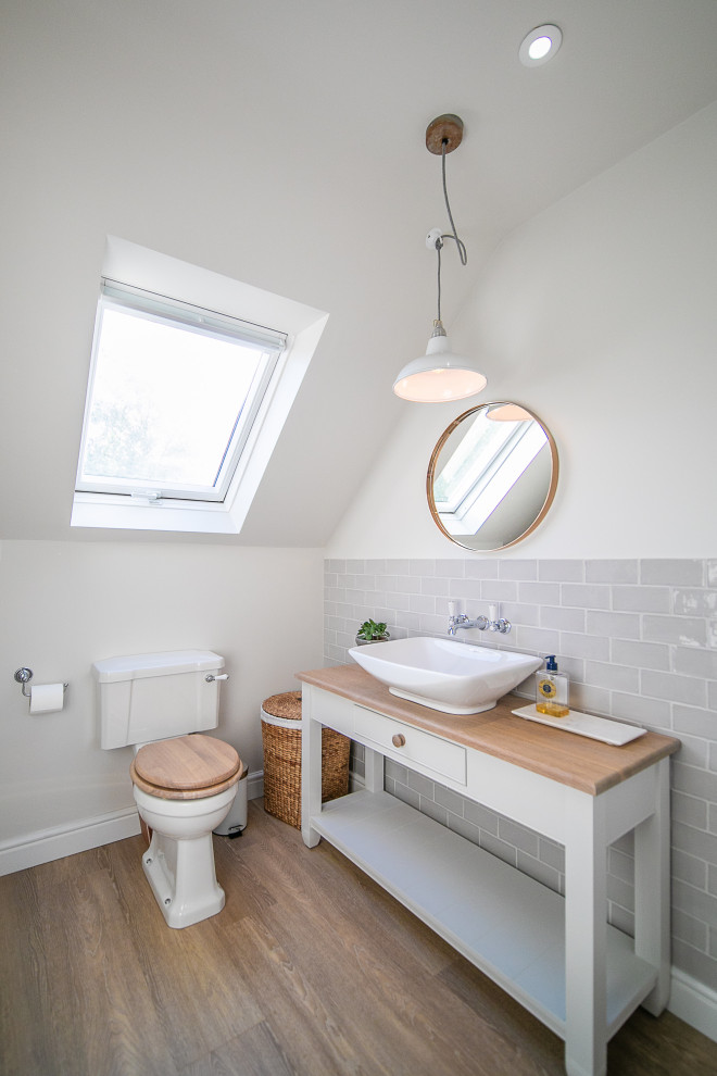 Design ideas for a medium sized traditional shower room bathroom in Hampshire with open cabinets, white cabinets, grey tiles, metro tiles, white walls, a vessel sink, wooden worktops, brown floors, beige worktops, a single sink and a freestanding vanity unit.