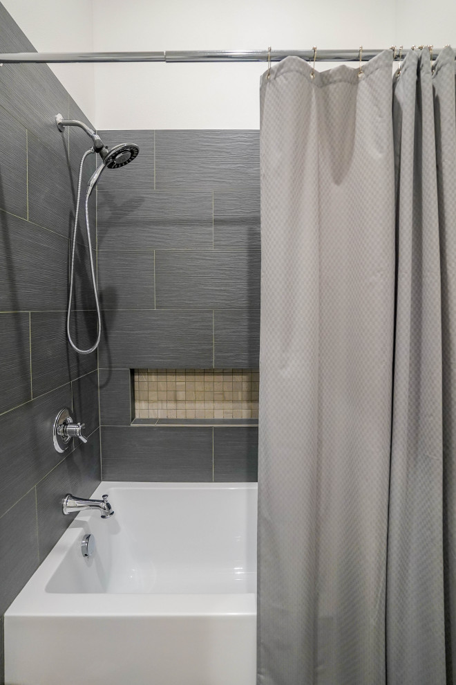 Photo of a small traditional bathroom in Seattle with recessed-panel cabinets, brown cabinets, an alcove bath, a shower/bath combination, a one-piece toilet, grey tiles, white walls, a built-in sink, a shower curtain, white worktops, a single sink, a floating vanity unit and a vaulted ceiling.