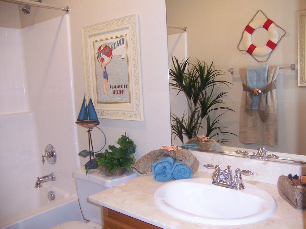 Bathroom - mid-sized tropical kids' bathroom idea in Las Vegas with a drop-in sink, medium tone wood cabinets, granite countertops, a one-piece toilet and beige walls