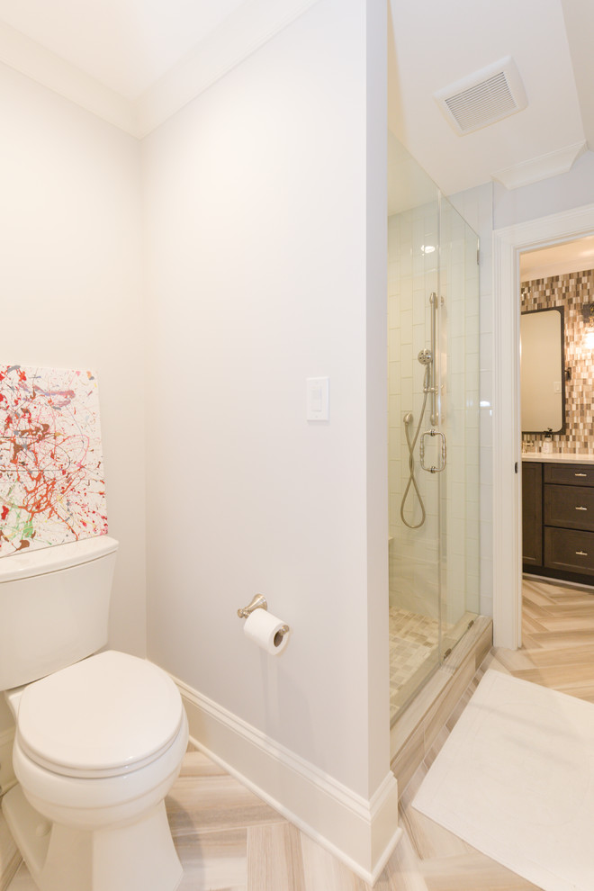 Inspiration for a large transitional kids' brown tile and mosaic tile ceramic tile walk-in shower remodel in Charlotte with recessed-panel cabinets, dark wood cabinets, a two-piece toilet, white walls, an undermount sink and quartzite countertops