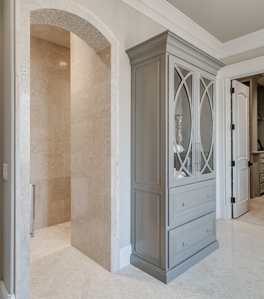 Design ideas for a large classic ensuite wet room bathroom in Oklahoma City with raised-panel cabinets, grey cabinets, a freestanding bath, a two-piece toilet, beige tiles, marble tiles, beige walls, marble flooring, a submerged sink, quartz worktops, beige floors and an open shower.