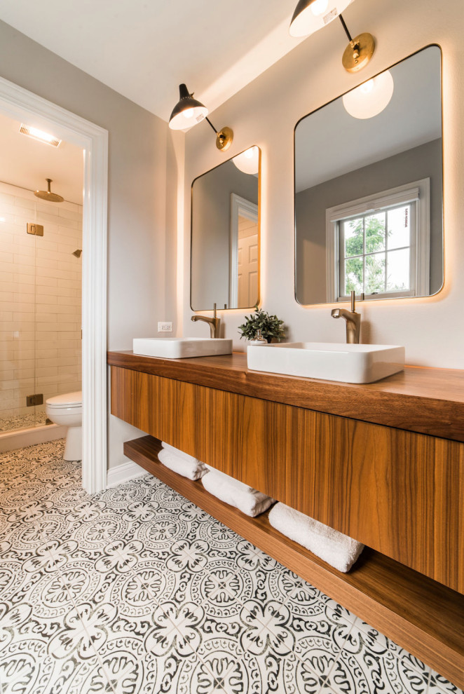 Alcove shower - mid-sized transitional white tile and ceramic tile ceramic tile alcove shower idea in Chicago with medium tone wood cabinets, a two-piece toilet, gray walls, a drop-in sink, wood countertops and a hinged shower door