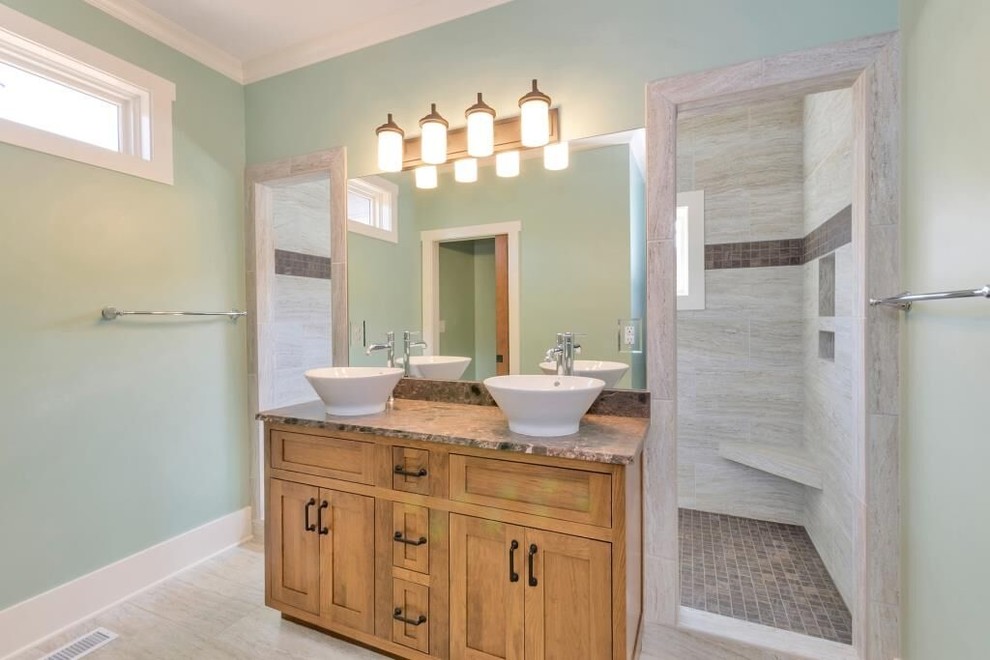 Photo of a medium sized farmhouse bathroom in Other with shaker cabinets, light wood cabinets, an alcove shower, green walls and a vessel sink.