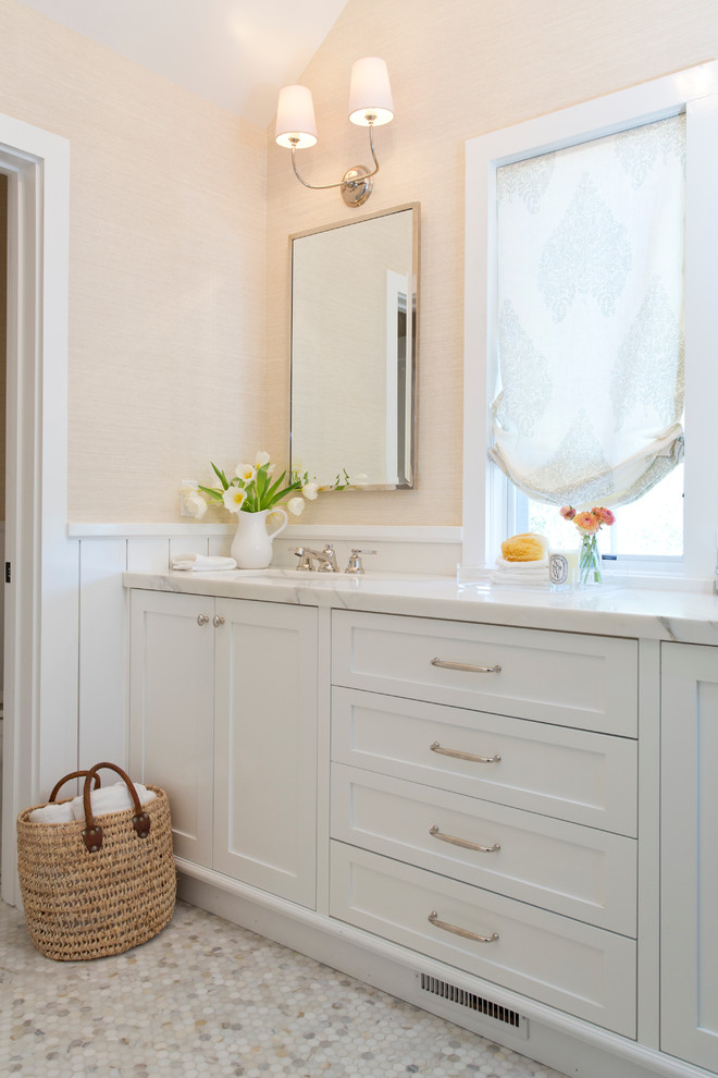 This is an example of a classic bathroom in San Francisco with white cabinets and mosaic tile flooring.
