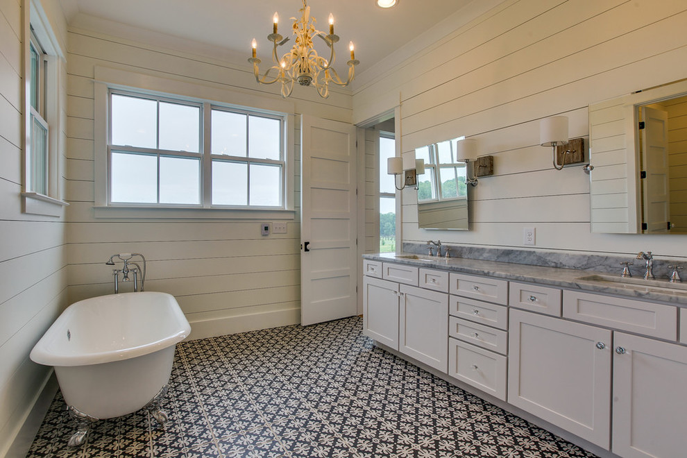 Bathroom - large country 3/4 black and white tile and ceramic tile ceramic tile bathroom idea in Nashville with shaker cabinets, white cabinets, a two-piece toilet, white walls, an undermount sink and solid surface countertops