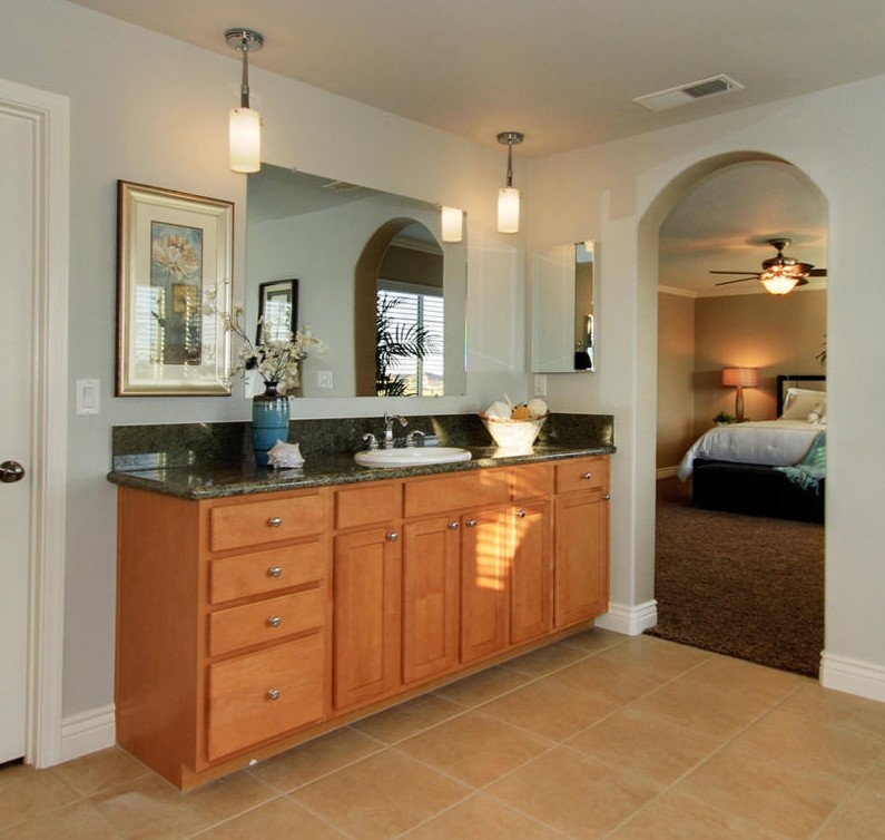 Traditional bathroom in Sacramento with a built-in sink, shaker cabinets, light wood cabinets and granite worktops.