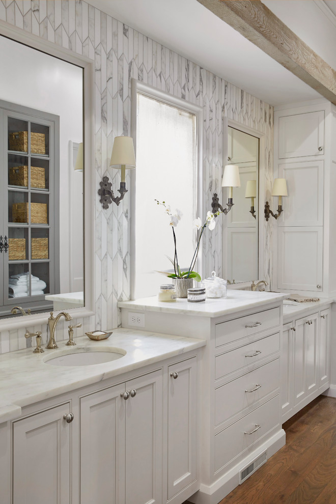 Large transitional master white tile and subway tile light wood floor and beige floor alcove shower photo in Birmingham with beaded inset cabinets, white cabinets, white walls, an undermount sink, marble countertops and a hinged shower door