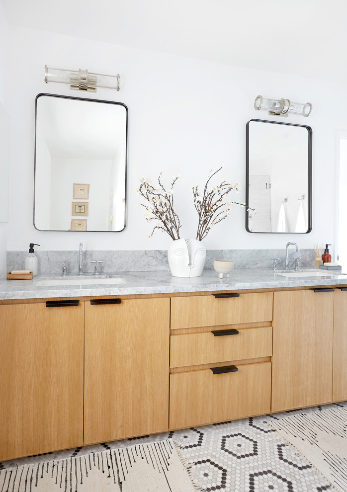 Modern inredning av ett stort grå grått badrum, med släta luckor, skåp i mellenmörkt trä, vita väggar, mosaikgolv, ett undermonterad handfat och flerfärgat golv