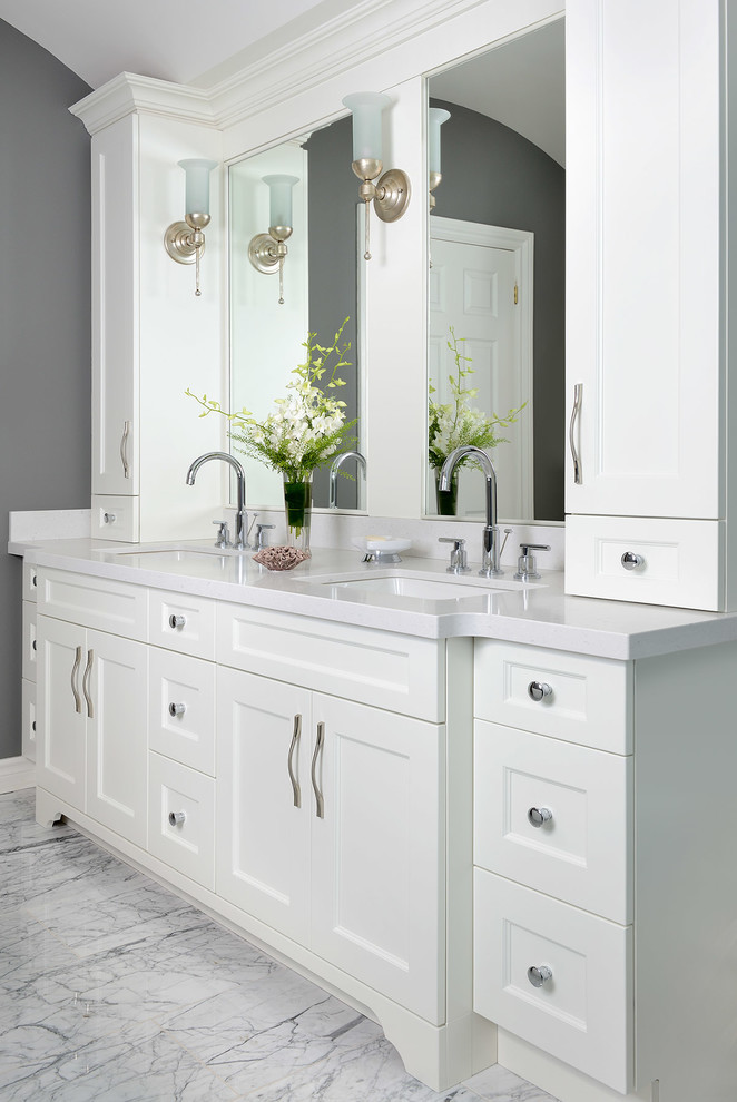 Example of a mid-sized transitional master stone tile marble floor bathroom design in Toronto with shaker cabinets, white cabinets, gray walls, an undermount sink and solid surface countertops
