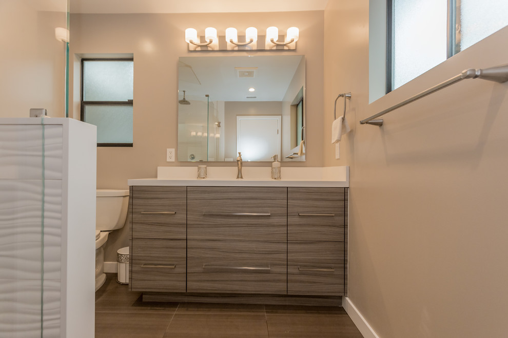 Example of a mid-sized trendy 3/4 white tile and porcelain tile porcelain tile walk-in shower design in Los Angeles with flat-panel cabinets, medium tone wood cabinets, a two-piece toilet, gray walls, an undermount sink and quartz countertops
