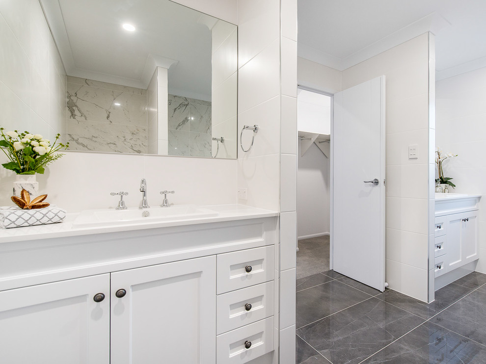 Medium sized nautical ensuite bathroom in Brisbane with shaker cabinets, white cabinets, a freestanding bath, a walk-in shower, grey tiles, porcelain tiles, white walls, porcelain flooring, a built-in sink, quartz worktops, grey floors and white worktops.