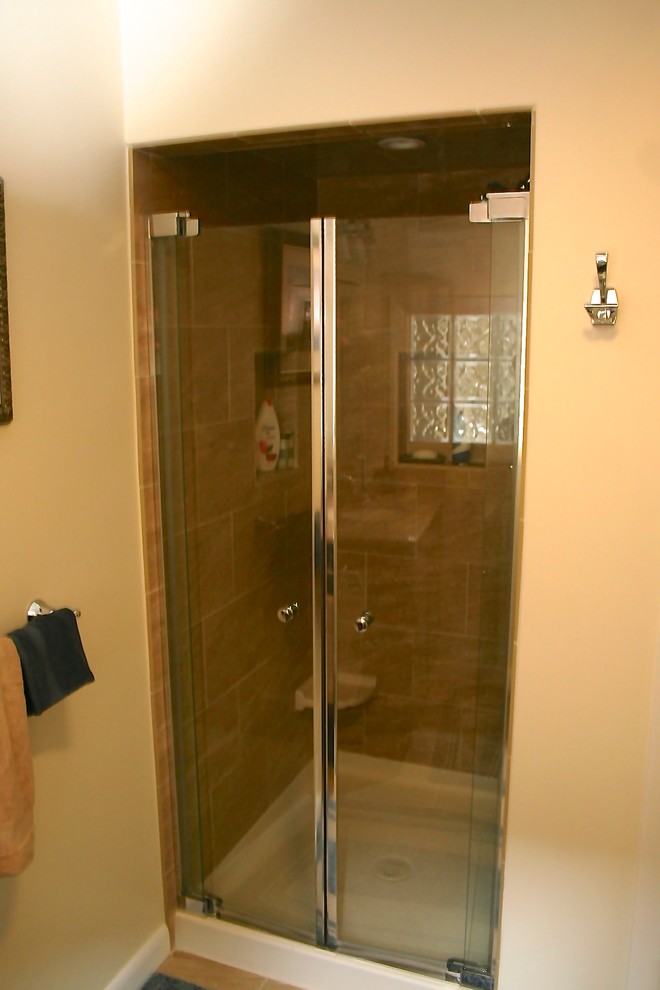 This is an example of a medium sized classic ensuite bathroom in Providence with a submerged sink, an alcove shower, a two-piece toilet, flat-panel cabinets, dark wood cabinets, granite worktops, beige tiles, porcelain tiles, white walls and porcelain flooring.