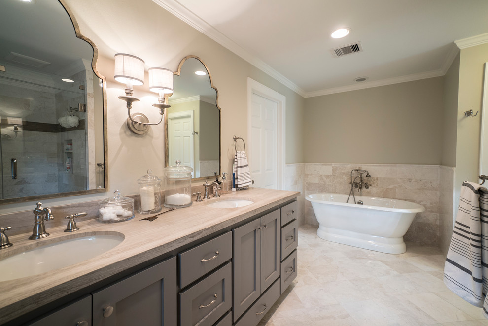 Design ideas for a medium sized classic ensuite bathroom in Houston with a submerged sink, shaker cabinets, grey cabinets, a freestanding bath, a corner shower, grey tiles, metro tiles, beige walls and travertine flooring.