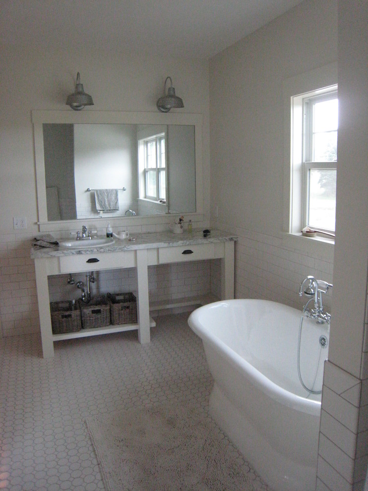 Small farmhouse ensuite bathroom in Grand Rapids with a built-in sink, open cabinets, white cabinets, limestone worktops, an alcove shower, a one-piece toilet, white tiles, ceramic tiles, white walls, ceramic flooring and a freestanding bath.
