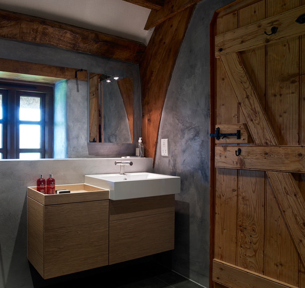 Design ideas for a medium sized rural family bathroom in Devon with a console sink, a freestanding bath, a built-in shower, a wall mounted toilet, grey tiles, stone tiles, grey walls and porcelain flooring.