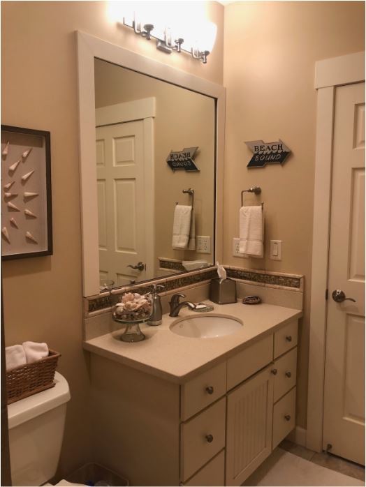 Inspiration for a medium sized classic bathroom in Minneapolis with louvered cabinets, white cabinets, a walk-in shower, a two-piece toilet, a submerged sink, an open shower, beige tiles, porcelain tiles, beige walls, porcelain flooring, solid surface worktops, beige floors and beige worktops.