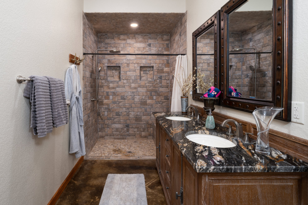 Bathroom - huge southwestern stone tile concrete floor, brown floor, double-sink and exposed beam bathroom idea in Other with furniture-like cabinets, brown cabinets, white walls, a drop-in sink, granite countertops and a floating vanity