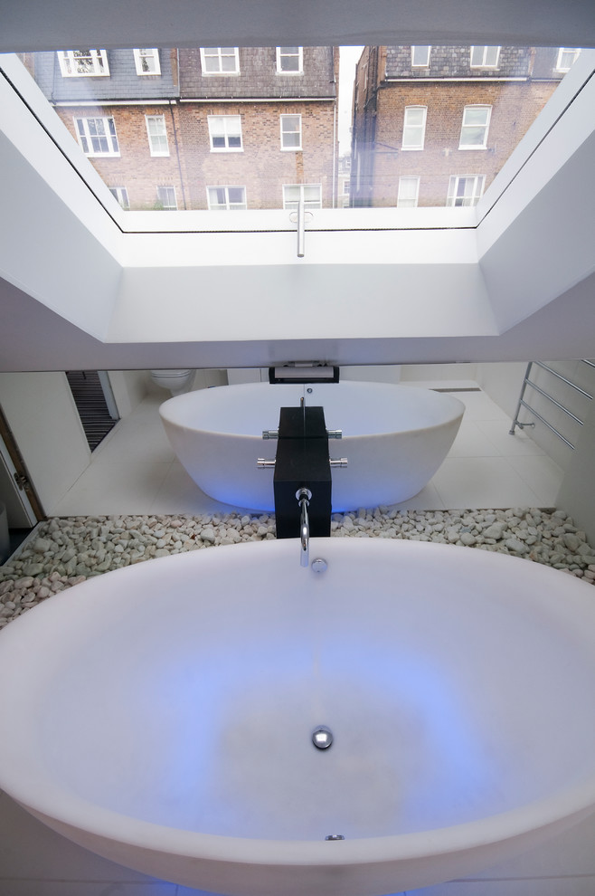 Design ideas for a medium sized contemporary bathroom in London with a freestanding bath and white walls.