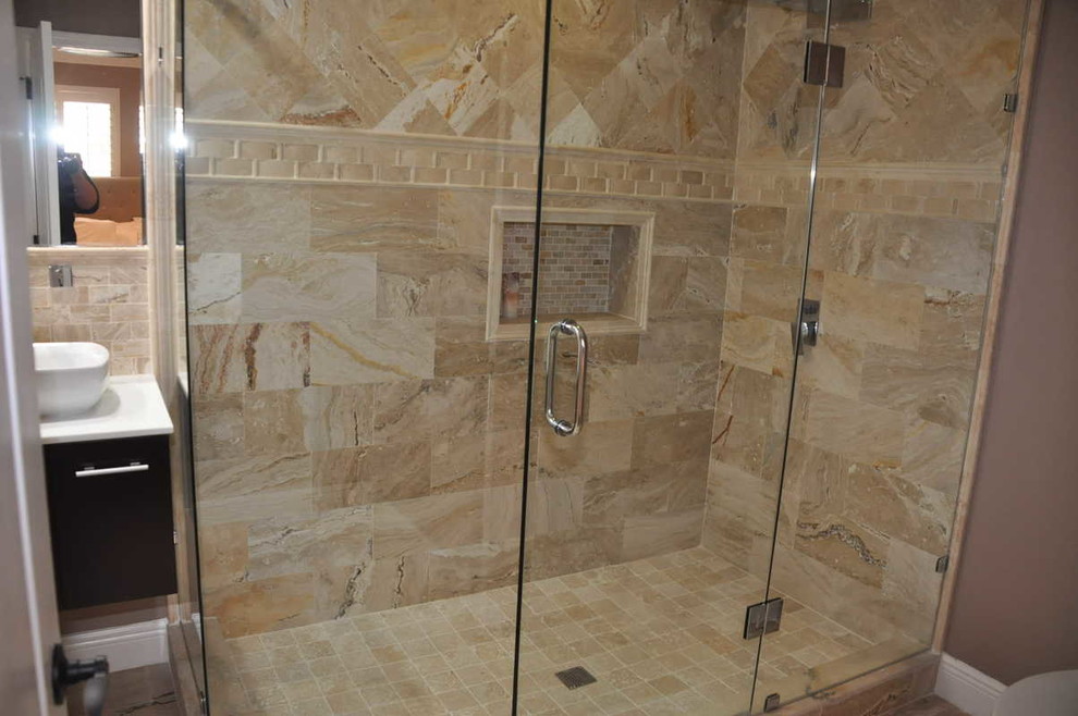 Inspiration for a large mediterranean ensuite bathroom in Tampa with a vessel sink, flat-panel cabinets, brown cabinets, limestone worktops, a double shower, beige tiles, stone tiles, beige walls and travertine flooring.