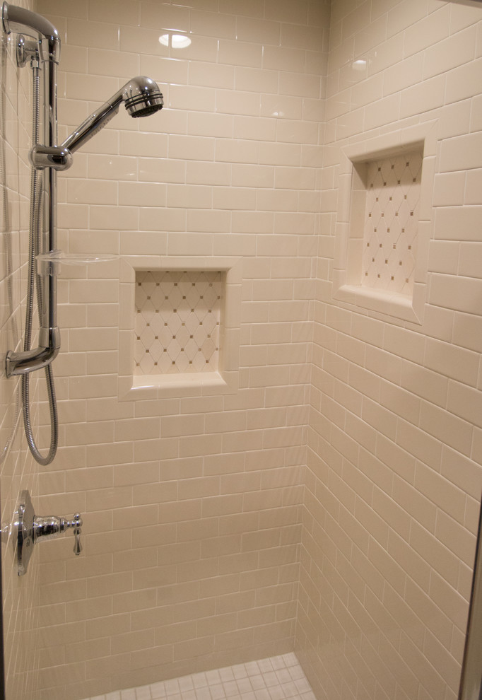 Inspiration for a small timeless master beige tile and subway tile porcelain tile alcove shower remodel in Other with an undermount sink, raised-panel cabinets, medium tone wood cabinets, quartz countertops, a two-piece toilet and brown walls