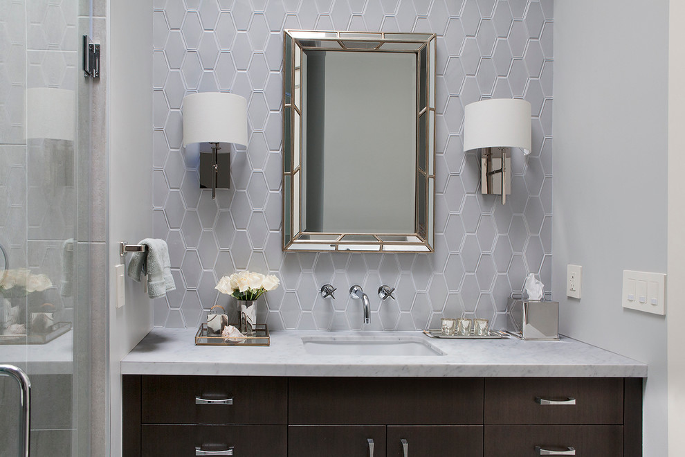 Example of a small transitional master gray tile and ceramic tile porcelain tile bathroom design in San Francisco with a drop-in sink, flat-panel cabinets, dark wood cabinets, marble countertops, a wall-mount toilet and gray walls