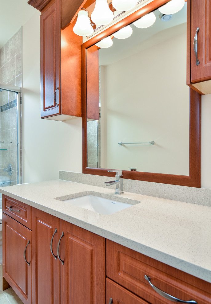 This is an example of a small contemporary bathroom in Vancouver with raised-panel cabinets, a submerged sink, light wood cabinets and quartz worktops.