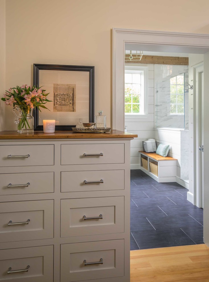 This is an example of a medium sized rural ensuite bathroom in Boston with freestanding cabinets, grey cabinets, a double shower, a one-piece toilet, marble tiles, a submerged sink, marble worktops, black floors, an open shower and medium hardwood flooring.