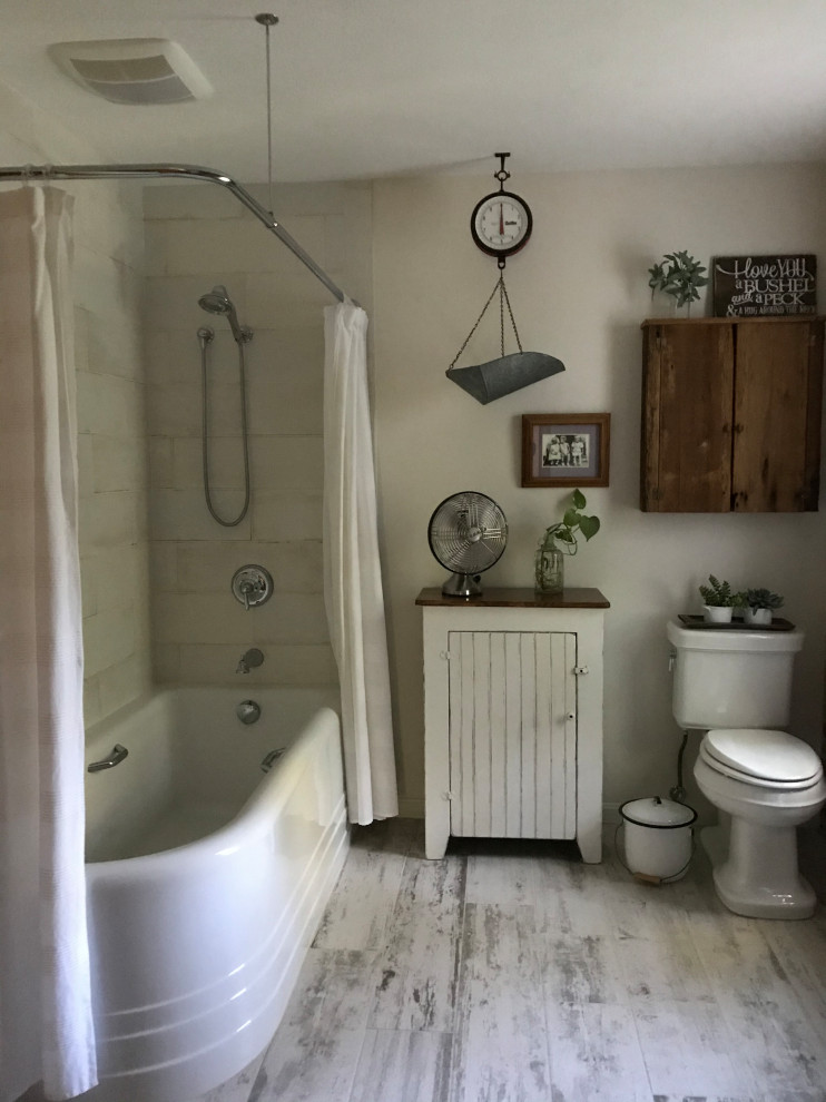 Photo of a medium sized rustic family bathroom in Cleveland with a corner bath, a shower/bath combination, a two-piece toilet, white tiles, ceramic tiles, white walls, porcelain flooring, a pedestal sink, multi-coloured floors, a shower curtain, white worktops, a single sink, brick walls and a wall niche.