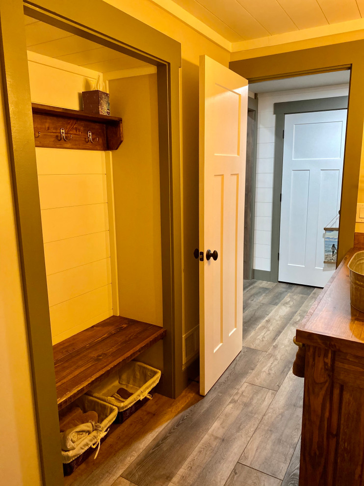 Mid-sized mountain style 3/4 gray tile and ceramic tile vinyl floor, gray floor, single-sink, shiplap ceiling and shiplap wall bathroom photo in Detroit with shaker cabinets, medium tone wood cabinets, a one-piece toilet, white walls, a vessel sink, wood countertops, brown countertops and a built-in vanity