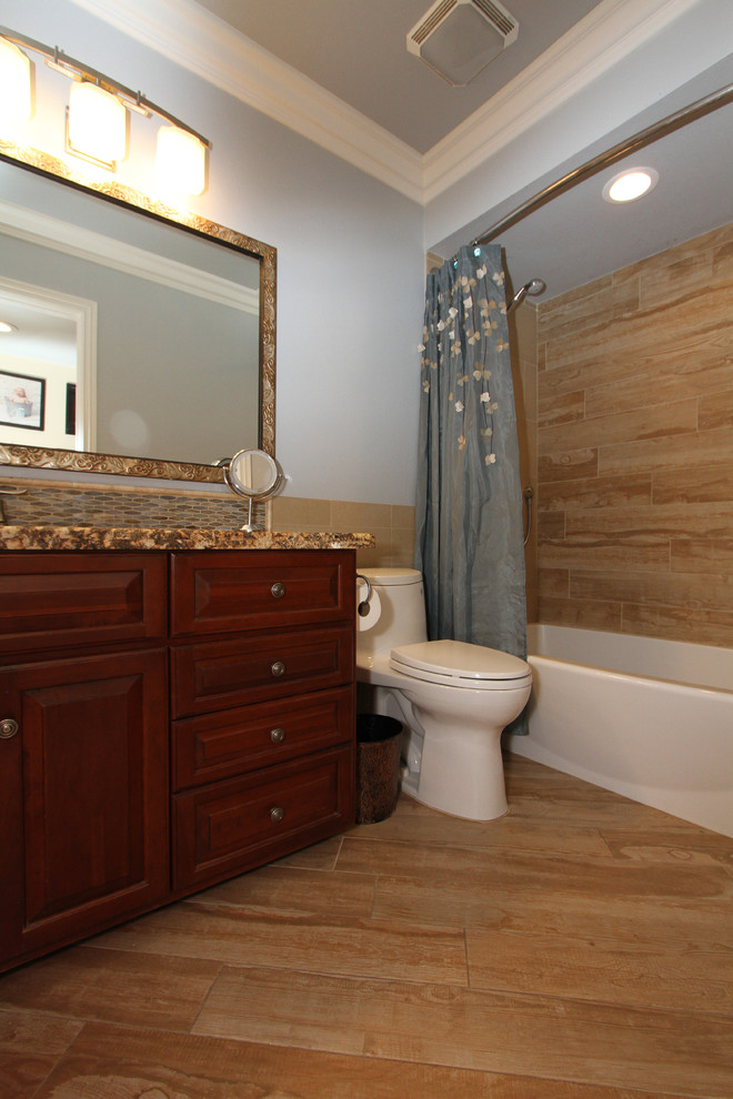Small traditional shower room bathroom in Orange County with raised-panel cabinets, dark wood cabinets, an alcove bath, a shower/bath combination, a one-piece toilet, beige tiles, porcelain tiles, grey walls, porcelain flooring, a submerged sink, granite worktops, beige floors and a shower curtain.