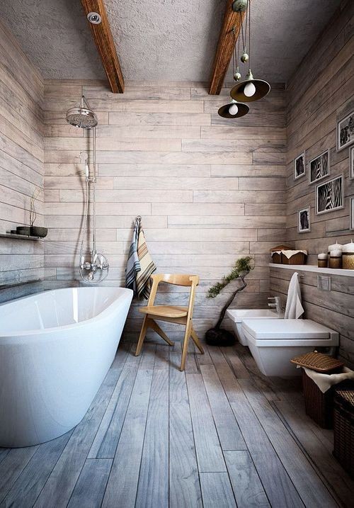 This is an example of a medium sized rustic bathroom in London with wooden worktops, a freestanding bath, brown tiles, brown walls and light hardwood flooring.