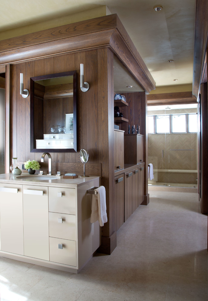 Mountain style bathroom photo in Denver with an undermount sink, flat-panel cabinets, beige cabinets and beige walls