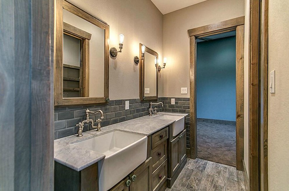 Bathroom - mid-sized rustic gray tile and stone tile slate floor bathroom idea in Houston with recessed-panel cabinets, dark wood cabinets, granite countertops, beige walls and a drop-in sink
