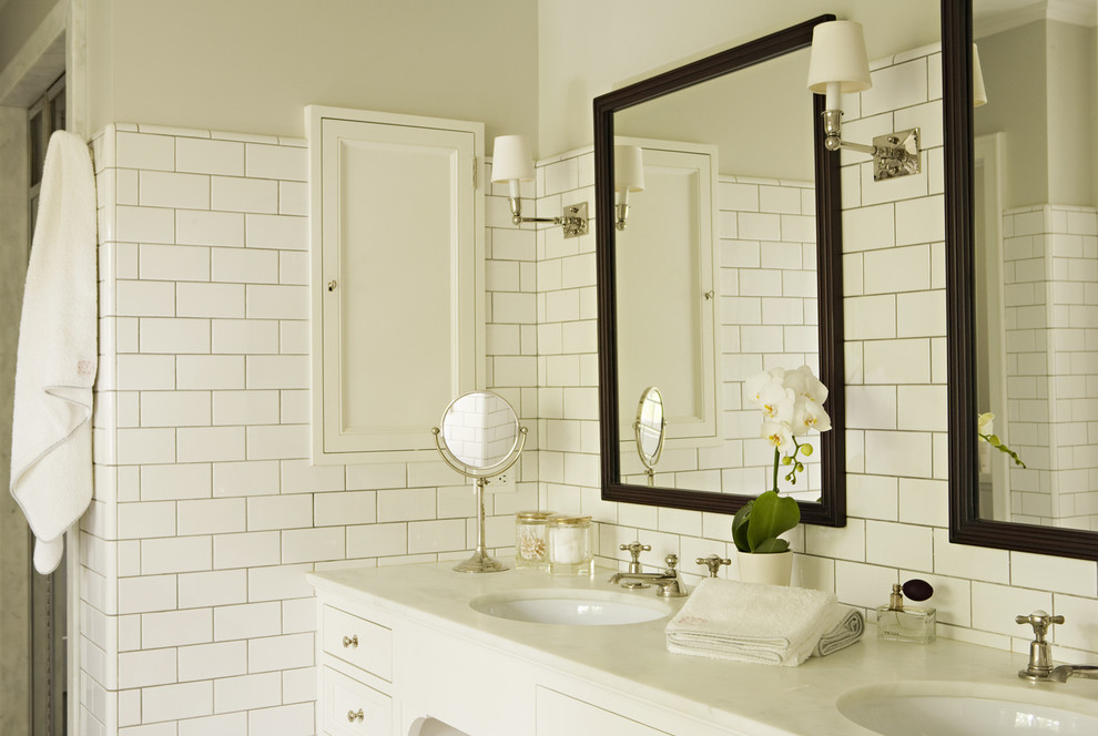 Elegant white tile and subway tile bathroom photo in Los Angeles with an undermount sink and white cabinets