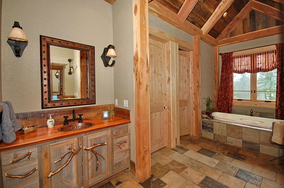 Bathroom - large rustic master brown tile and porcelain tile dark wood floor and brown floor bathroom idea in Other with flat-panel cabinets, medium tone wood cabinets, a wall-mount toilet, beige walls, a drop-in sink and wood countertops