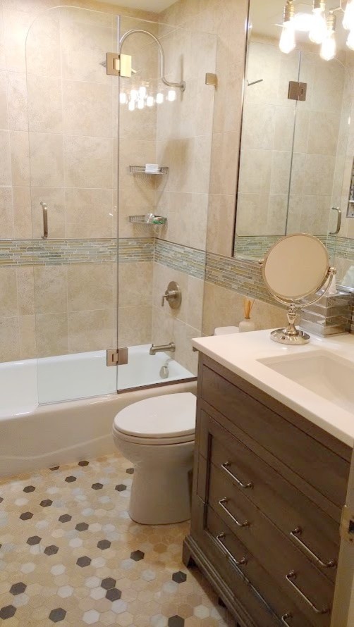 Inspiration for a small transitional kids' beige tile limestone floor alcove bathtub remodel in Bridgeport with recessed-panel cabinets, medium tone wood cabinets, a one-piece toilet, black walls, an undermount sink and solid surface countertops