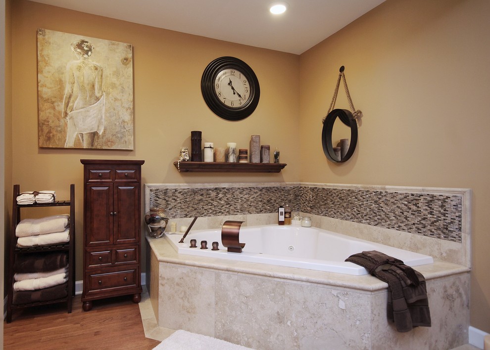 Bild på ett mellanstort rustikt en-suite badrum, med ett undermonterad handfat, luckor med upphöjd panel, skåp i mörkt trä, bänkskiva i kalksten, ett hörnbadkar, en dusch i en alkov, en toalettstol med hel cisternkåpa, beige kakel, porslinskakel, beige väggar och mellanmörkt trägolv