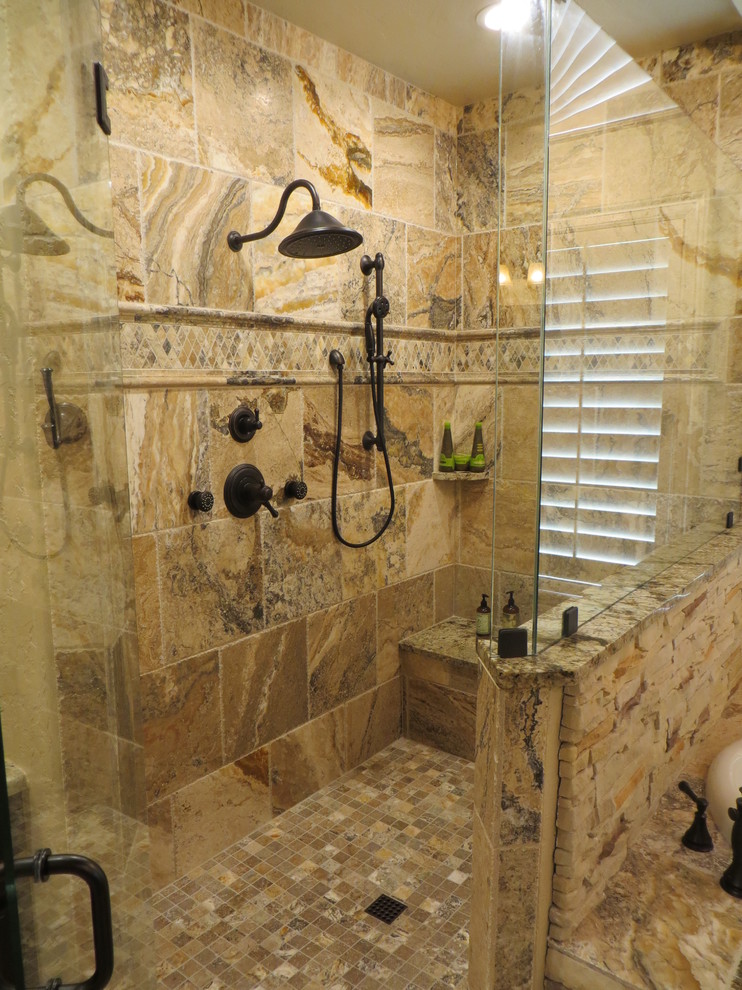 Large rustic ensuite bathroom in Dallas with a submerged sink, raised-panel cabinets, dark wood cabinets, granite worktops, a built-in bath, a corner shower, a two-piece toilet, brown tiles, stone tiles, beige walls and ceramic flooring.