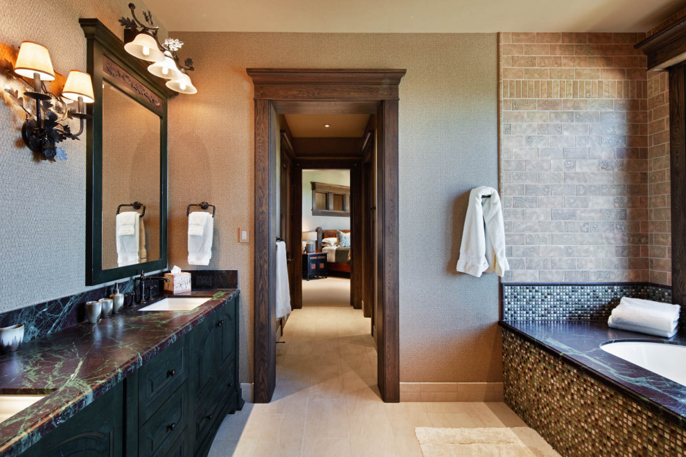 Идея дизайна: ванная комната в стиле рустика с фасадами с выступающей филенкой, черными фасадами, полновстраиваемой ванной, коричневой плиткой, серыми стенами, врезной раковиной, бежевым полом и разноцветной столешницей