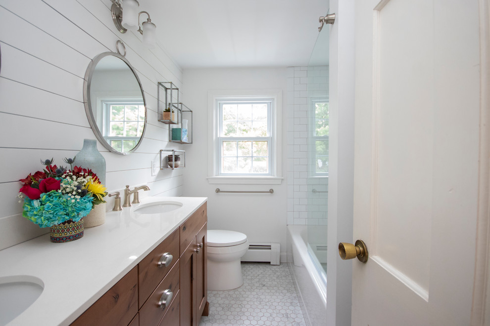 Medium sized country ensuite bathroom in Providence with recessed-panel cabinets, dark wood cabinets, a built-in bath, a shower/bath combination, a two-piece toilet, white tiles, metro tiles, white walls, porcelain flooring, a submerged sink, quartz worktops, white floors, a hinged door and white worktops.