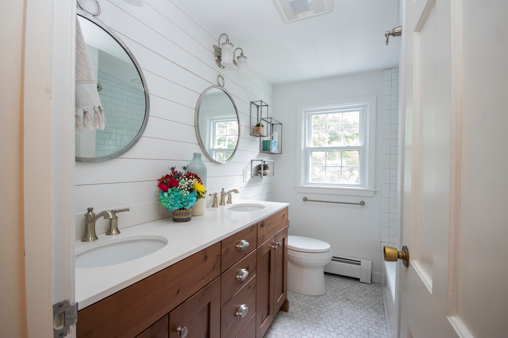 Inspiration for a mid-sized farmhouse master white tile and subway tile porcelain tile and white floor bathroom remodel in Providence with recessed-panel cabinets, dark wood cabinets, a two-piece toilet, white walls, an undermount sink, quartzite countertops, a hinged shower door and white countertops
