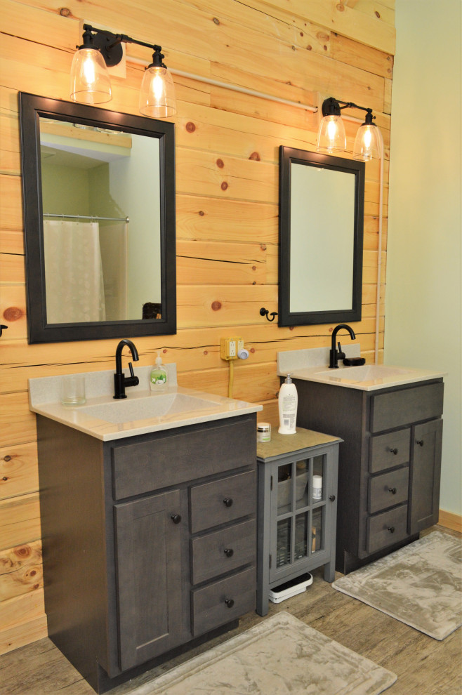 Example of a large mountain style master light wood floor, gray floor, single-sink, vaulted ceiling and wood wall bathroom design in Other with shaker cabinets, gray cabinets, brown walls, an integrated sink, white countertops and a freestanding vanity