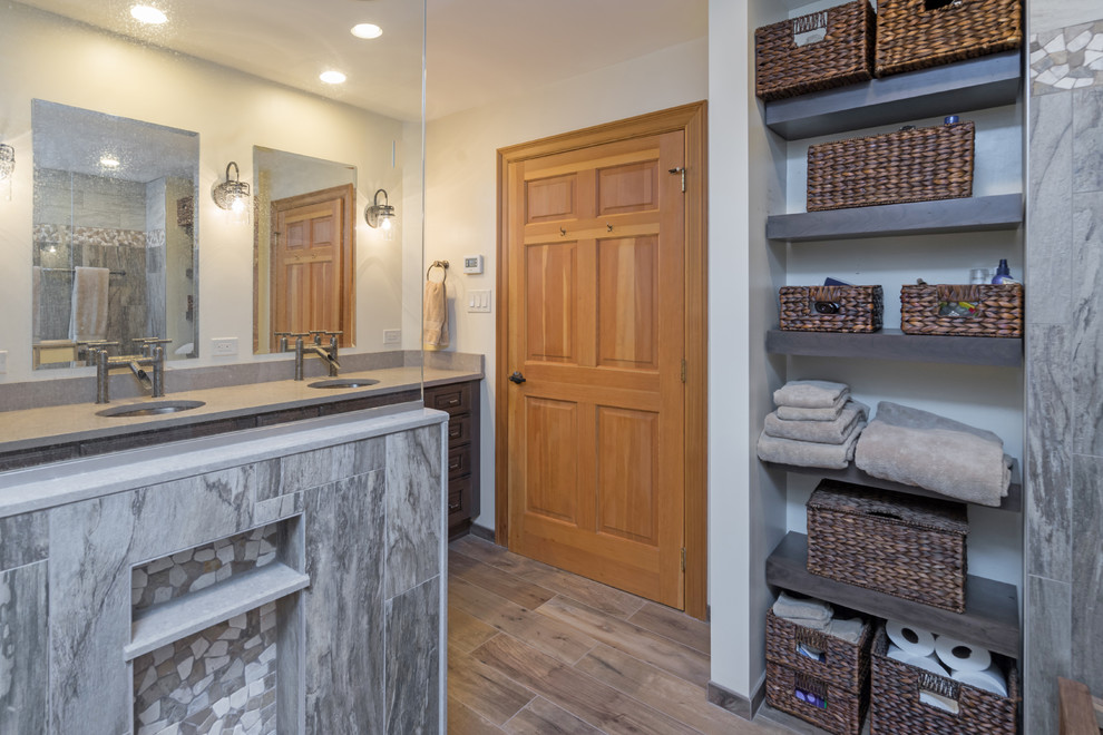 Inspiration for a large rustic master gray tile and porcelain tile porcelain tile and brown floor bathroom remodel in Philadelphia with raised-panel cabinets, distressed cabinets, a two-piece toilet, beige walls, quartz countertops and beige countertops