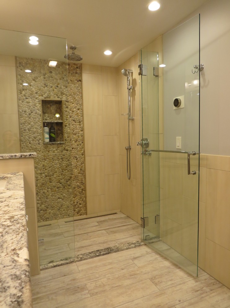 Example of a mid-sized transitional master multicolored tile and pebble tile porcelain tile alcove shower design in Portland Maine with an undermount sink, recessed-panel cabinets, gray cabinets, granite countertops, a wall-mount toilet and blue walls