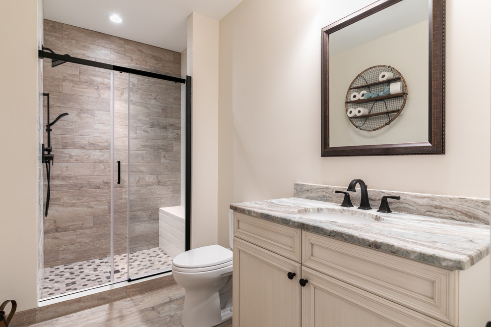 Medium sized classic shower room bathroom in DC Metro with recessed-panel cabinets, beige cabinets, a corner shower, a two-piece toilet, multi-coloured tiles, porcelain tiles, beige walls, porcelain flooring, a submerged sink, engineered stone worktops, brown floors, an open shower and white worktops.