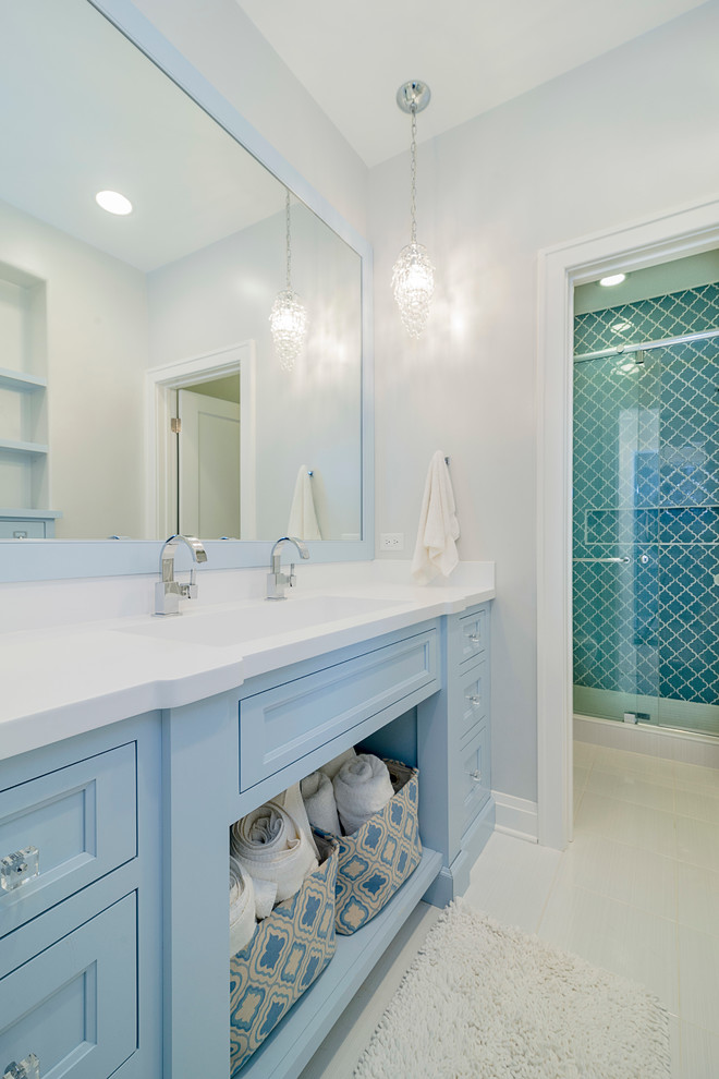 Medium sized eclectic family bathroom in Chicago with open cabinets, blue cabinets, an alcove shower, a two-piece toilet, white tiles, porcelain tiles, white walls, porcelain flooring, a trough sink and solid surface worktops.