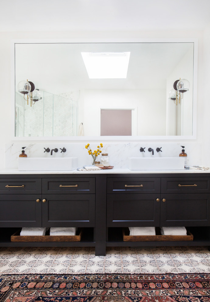 Photo of a bathroom in Los Angeles with a vessel sink and black cabinets.