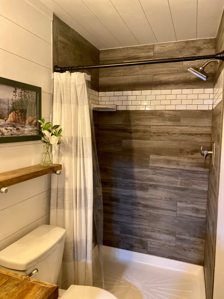 Example of a mid-sized mountain style 3/4 vinyl floor, gray floor, single-sink, shiplap ceiling and shiplap wall doorless shower design in Detroit with furniture-like cabinets, brown cabinets, a one-piece toilet, white walls, a vessel sink, wood countertops, brown countertops and a built-in vanity