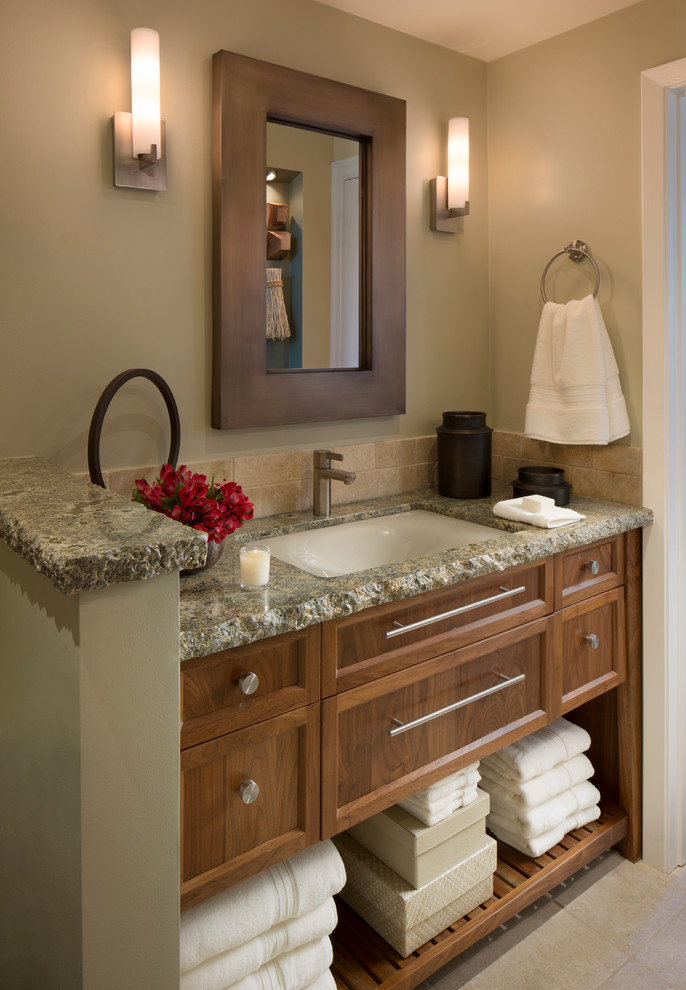 Mid-sized tuscan beige tile and stone tile travertine floor bathroom photo in San Francisco with an undermount sink, furniture-like cabinets, medium tone wood cabinets, granite countertops, a one-piece toilet and green walls