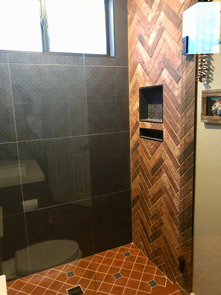Small rustic shower room bathroom in San Diego with recessed-panel cabinets, brown cabinets, a walk-in shower, a two-piece toilet, blue tiles, terracotta tiles, beige walls, terracotta flooring, a submerged sink, red floors and a hinged door.